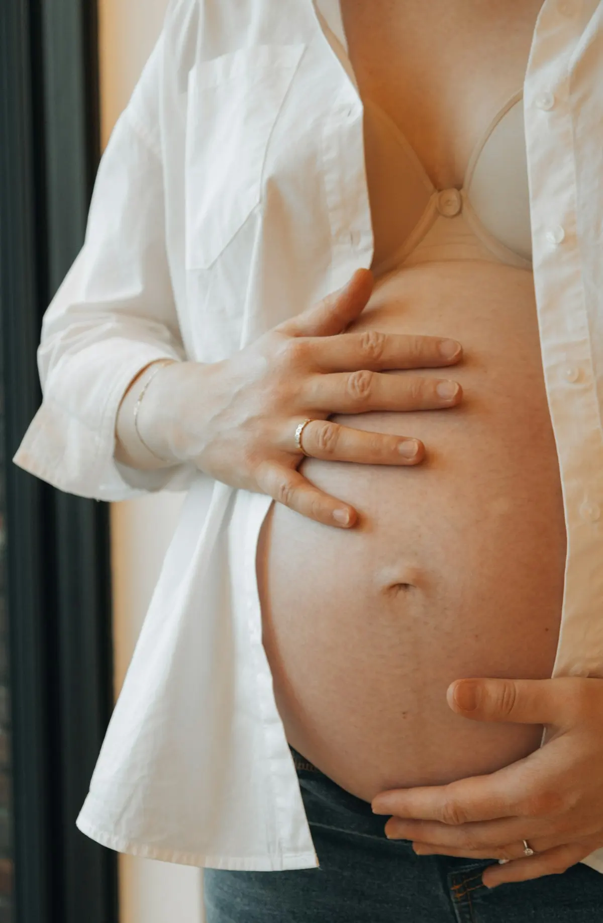 Femme enceinte, une main sur le ventre