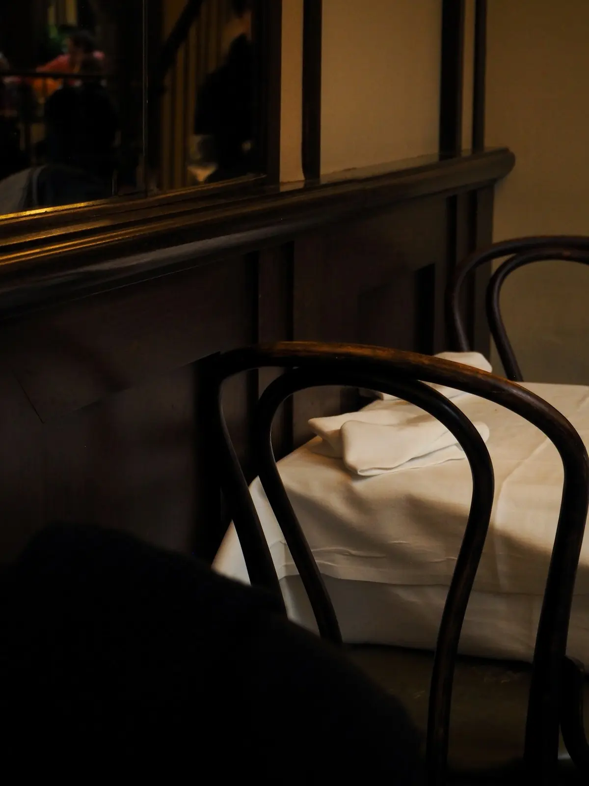 Table dressée dans la pénombre, verres à vin